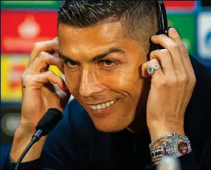  ??  ?? Defiant: A bejewelled Cristiano Ronaldo faces the media yesterday