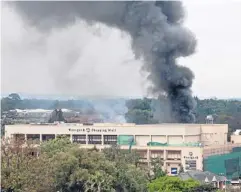  ?? AP ?? A plume of black smoke billows over the Westgate mall, in Nairobi, Kenya, yesterday, where a hostage siege was in its third day. Security forces have been attempting to rescue an unknown number of hostages inside the mall held by al-Qaeda-linked...