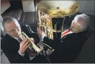  ?? PICTURES: LORNE CAMPBELL/GUZELIAN ?? BRASS FAMILY: Tuba player Terry Hardy and his son Rob, who plays the cornet, rehearse in Terry’s house. They were due to play at the Yorkshire Brass Band Championsh­ips.