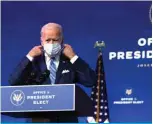  ?? — AFP ?? WILMINGTON, Delaware: US President-elect Joe Biden takes off his mask as he arrives at the Queen theater to present his plan for combating the coronaviru­s and jump-starting the nation’s economy in Wilmington, Delaware.