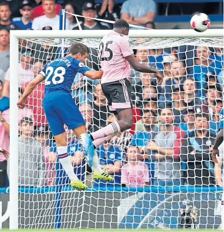  ?? Pictures: Getty Images. ?? Wilfred Ndidi of Leicester heads home his team’s equaliser against Chelsea.