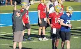  ?? Al Seib Los Angeles Times ?? CHIP KELLY, left, leads the first spring practice. “I have no idea what this team is all about,” he said, “so that’s what the whole spring will be about.”