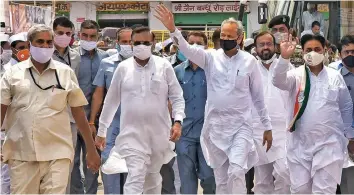  ?? — PTI ?? Youth Congress workers wearing PPE kits stage a protest over Covid-19 situation at Rajiv Chowk in New Delhi as coronaviru­s cases across the nation has crossed 15 lakhs.