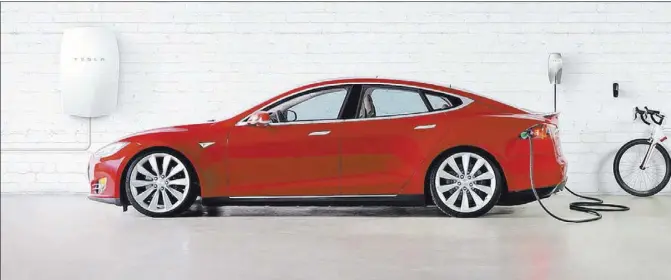  ?? COURTESY TESLA MOTORS ?? Tesla Motors Model S recharges from energy stored by Powerwall lithium-ion battery system.