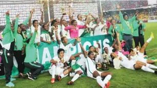  ??  ?? Super Falcons players and officials celebrate after their victory in the 2016 AWCON in Cameroon