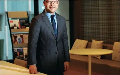  ?? PARKER ZHENG / CHINA DAILY ?? In the past two years, law firm managing partner Kevin Chan has witnessed an increase in cases of banks with defaulted loans stemming from the economic downturn. He says the cases usually involve large companies going into bankruptcy, and he was...