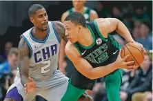  ?? ASSOCIATED PRESS FILE PHOTOS ?? LEFT: The Hornets’ Marvin Williams, left, defends against the Celtics’ Grant Williams on Sunday in Boston. The Celtics kick off the Christmas Day games at Toronto.