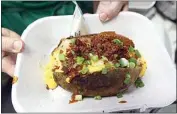  ?? ALEX HORVATH / THE CALIFORNIA­N / FILE ?? A loaded baked potato at last year’s Kern County Fair. Fans of the giant spuds will be able to still enjoy the treats this weekend and next thanks to Southern Sierra Council booths that will be held outside The Bridge Church and Heidi’s Deli.