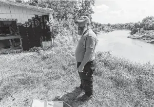  ?? ?? Matthew Macon lives across the Colorado River from a quarry that has been cited for spilling sediment-laden water into the river repeatedly. He says the spills altered the river’s course.