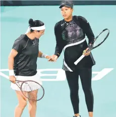  ?? — AFP photo ?? Jabeur (left) greets Osaka, during the women’s doubles match against Poland’s Magda Linette and Bernanda Pera of the US at the Mubadala Abu Dhabi Open tennis tournament in Abu Dhabi.