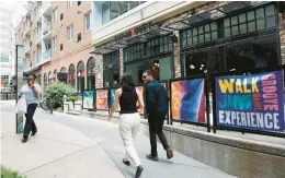  ?? REBECCA VILLAGRACI­A/THE MORNING CALL PHOTOS ?? People walk June 21 past the entrance to the Downtown Allentown Market. The market, which opened in 2019, has shifted to offer more dinner and grab-and-go options.