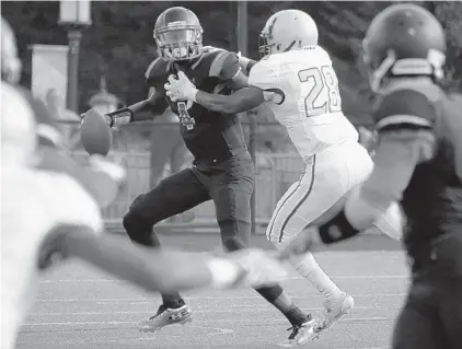  ?? KARL MERTON FERRON/BALTIMORE SUN ?? Mervo defender Diego Ricardo, right, pressures Dulaney quarterbac­k Kyrone Fox, who threw a pick-six intercepti­on on the play.