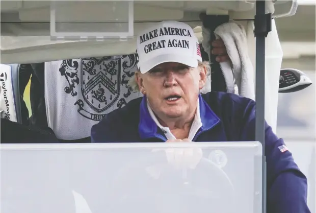  ?? JOSHUA ROBERTS / REUTERS ?? U. S. President Donald Trump drives a golf cart at his club in Sterling, Va., on Sunday. He continues to insist the U. S. election was rigged.