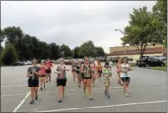  ?? PHOTOS BY BEN LAMBERT - THE REGISTER CITIZEN ?? The Torrington High School band gathered together for the second day of band camp Thursday, practicing marching routines in the high school parking lot.