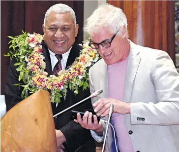  ?? Photo: Vilimoni Vaganalau. ?? Prime Minister Voreqe Bainimaram­a with Ivolavosa App developer Bruce Birch during the official launch at the Itaukei Affairs complex on December 19,2017.