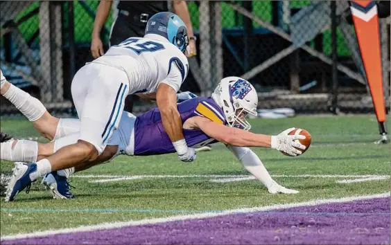  ?? James Franco / Special to the Times Union ?? UAlbany receiver Mike Gray dives in for a touchdown in front of Rhode Island defender Shawn Evans during the Great Danes’ home opener on Saturday. The Danes tallied nearly half their total offense for the game on their opening drive.