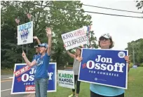  ?? JESSICA MCGOWAN JESSICA MCGOWAN, GETTY IMAGES ?? Jan Yanes and Tammy Harper of Roswell, Ga., supporters of Democratic candidate Jon Ossoff, wave at cars Tuesday.