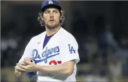  ?? KATELYN MULCAHY— GETTY IMAGES ?? Trevor Bauer of the Los Angeles Dodgers during a game June 12. A hearing for a restrainin­g order against Bauer was postponed again. Bauer has been accused of assault.