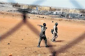  ?? Ebrahim Hamid / AFP / Getty Images ?? Sudan’s soldiers patrol the disputed border oil town of Heglig, which South Sudan invaded and relinquish­ed earlier this month.