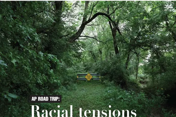  ?? Associated Press ?? above
There was a small collection of houses along Seventh Street, near where the outer edges of Vienna, Ill., bumps up against Little Cache Creek. Everyone who lived there was Black. Today, the settlement is an overgrown field. The street once led to a small bridge that crossed the creek, but the sign stands as a warning so no one tries to cross a bridge that isn’t there anymore.
