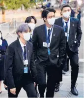  ?? JOHN MINCHILLO/GETTY-AFP ?? Suga, from left, Jin and RM, seen Sept. 20 in New York, have been diagnosed with COVID-19.