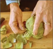  ??  ?? Remove any small, tough leaves toward the base on the stem of the artichoke.