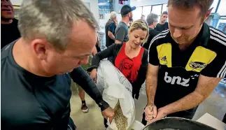  ??  ?? Jarrod Paltridge, Erina Wood and Hamish Sutherland add malt into water heated to 72C.