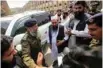  ?? - Reuters ?? HEARING: Hafiz Muhammad Saeed, centre, chief of JuD, arrives to appear before a court in Lahore, Pakistan October 17, 2017.