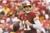  ?? ALEX BRANDON/AP ?? Washington Redskins quarterbac­k Alex Smith looks for a receiver in the second half of Sunday’s loss to the Colts in , in Landover.