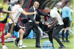  ?? /CATHERINE IVILL/GETTY IMAGES ?? Belgium coach Roberto Martinez celebrates with assistant coach Thierry Henry as their side march to semifinals.