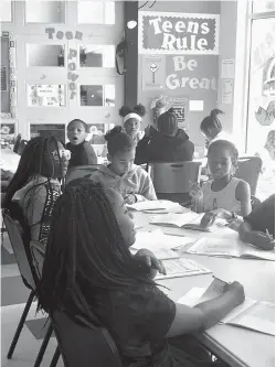  ?? Staff photo by Ashley Gardner ?? ■ Children at the Salvation Army Boys &amp; Girls Club study Money Matters, a program that teaches them about finances and how to budget money. The summer program is a combinatio­n of fun learning experience­s and recreation time.