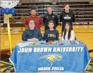  ?? Graham Thomas/Siloam Sunday ?? Siloam Springs senior forward Eli Jackson signed a letter of intent Wednesday to play soccer at John Brown University. Pictured are: Front from left, father Travis Jackson, Eli Jackson, mother Monica Jackson; back, assistant coach Ehldane Labitad, JBU men’s soccer coach Brenton Benware and Siloam Springs boys soccer coach Luke Shoemaker.