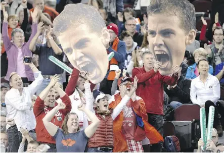  ??  ?? Fans wave cut-outs of Vasek Pospisil at a game against Great Britain’s Daniel Evans during their Davis Cup World Group tennis tie last month in Ottawa. Pospisil says he feeds off the emotion of the crowd during his matches.