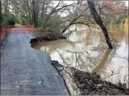  ??  ?? A large secdtion of Oostanaula River bank washed out over the weekend, taking a part of the trail below Chieftains Myuseum with it. Street Department Director Chad Hampton said a permanent fix may need to include a slight relocation of the trail.