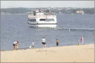  ?? Hearst Connecticu­t Media file photo ?? People enjoy the shoreline of Island Beach in 2002 as the Island Beach Ferry motors by.