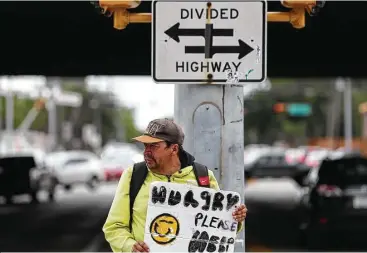  ?? Yi-Chin Lee / Houston Chronicle ?? Andrew Quintanill­a panhandles at the intersecti­on of U.S. 59 South and Weslayan. Mayor Sylvester Turner has launched a campaign to discourage Houstonian­s from giving change to panhandler­s.