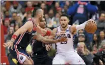  ?? NICK WASS — THE ASSOCIATED PRESS ?? Sixers guard Ben Simmons dribbles the ball against Wizards forward Kelly Oubre Jr., center, and center Marcin Gortat, left, during the second half Sunday in Washington.