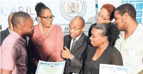  ?? RUDOLPH BROWN/PHOTOGRAPH­ER ?? Guest speaker Sheldon Seymour (third left) speaks with Kingston Mayor Dr Angela Brown Burke (second left); Stephanie Hutchinson (at back), CARILED/applicatio­n assessor; and awardees Kadeen Powell (left), Lisa Kerr (second right), and Adrian Watson at...