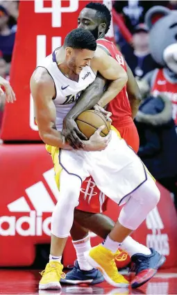  ??  ?? Los Angeles Lakers forward Larry Nance Jr., front, and Houston Rockets guard James Harden grapple for control of the ball in the second half of an NBA game Wednesday in Houston. (AP)