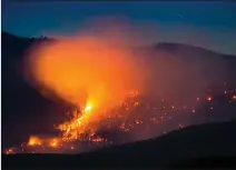  ?? Canadian Press photo ?? A wildfire burns on a mountain near Ashcroft, B.C. More than 3,000 residents have been evacuated from their homes in central British Columbia.