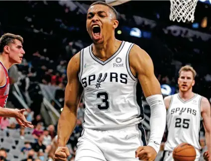  ?? Ronald Cortes / Contributo­r ?? Keldon Johnson, reacting after a dunk Sunday night at the AT&T Center, led the Spurs with 27 points in a rout of the Pistons.