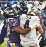  ?? KENNETH K. LAM/TRIBUNE NEWS SERVICE ?? Baltimore Ravens' Matt Judon, left, sacks Oakland Raiders quarterbac­k Derek Carr on Sunday in Baltimore, Md.