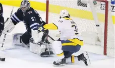  ?? TREVOR HAGAN/THE CANADIAN PRESS ?? Nashville forward Ryan Hartman scored the game-winning goal on Winnipeg goaltender Connor Hellebuyck in a wild 6-5 contest between division rivals on Tuesday.