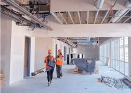  ??  ?? STC managers Cara Michaliszy­n, left, and Eri Hoshi stand in the Lobo Rainforest building’s north-central corridor, where the front entrance and reception area will be.