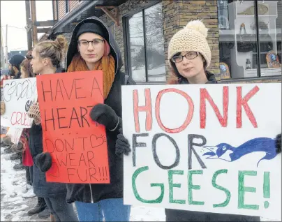  ?? MITCH MACDONALD/THE GUARDIAN ?? Hilary Wood, left, and Jennifer O’Brien, right, hold placards outside of Island Activewear on University Avenue Saturday while protesting against Canada Goose’s use of coyote fur and goose down in their jackets. Wood said the group was one of about 16...