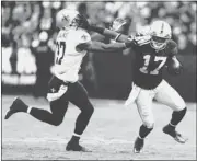  ?? JANE TYSKA/ STAFF ?? Raiders receiver Denarius Moore ( 17) stiff arms the Saints’ Malcolm Jenkins after his lone reception.