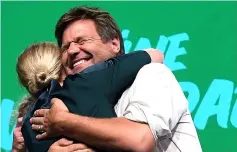  ??  ?? Top candidate of the ecologist Greens party in Bavaria Katharina Schulze (left) and Ludwig Hartmann embrace on stage at the election party after the Bavaria state election in Munich, southern Germany. — AFP photo