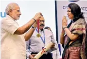  ??  ?? Prime Minister Narendra Modi presents an award to CBDT chairperso­n Anita Kapur for excellence in public administra­tion during the Civil Services Day function in New Delhi on Tuesday.