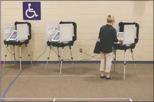  ?? The Associated Press ?? VOTER BALLOT: A voter casts her ballot during Georgia’s primary election runoff at Chase Street Elementary in Athens, Ga., Tuesday.