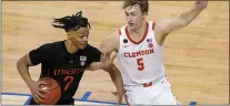  ?? GERRY BROOME - THE ASSOCIATED PRESS ?? Miami’s Isaiah Wong, left, tries to dribble past Clemson’s Hunter Tyson during the ACC tournament.